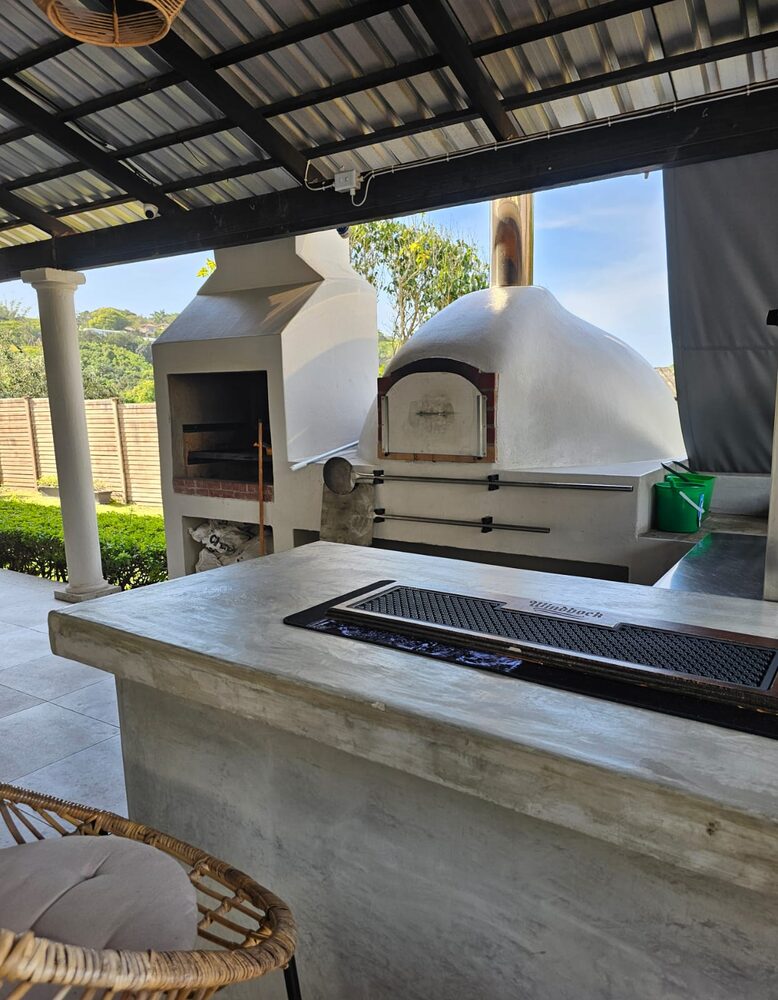 The outdoor braai and pizza area with sea view at Umdlalo Lodge
