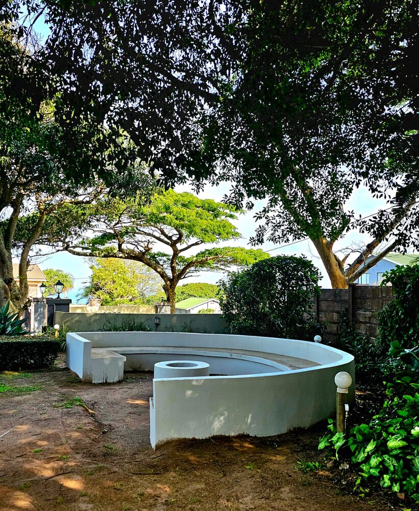 A garden bench with sea view at Umdlalo Lodge, Umtentweni