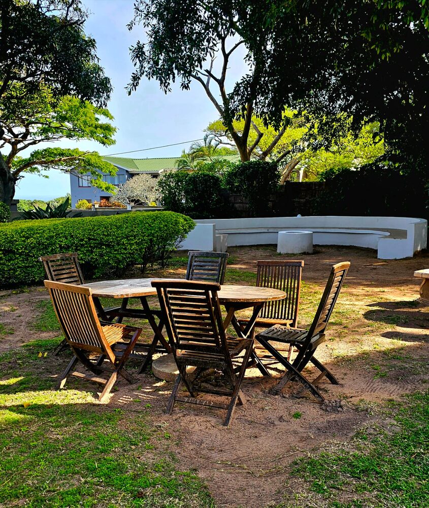 Outdoor garden dining under the trees at Umdlalo Lodge